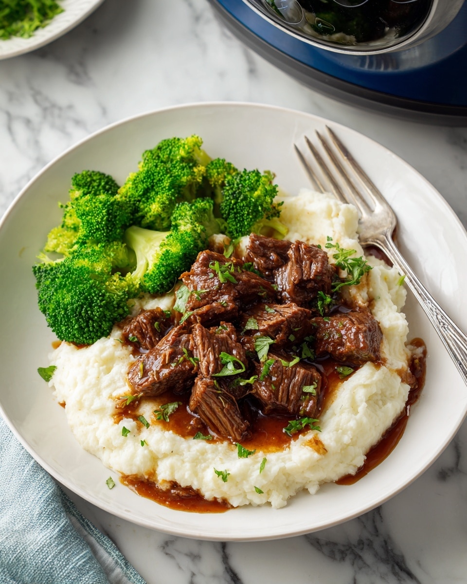 A white shallow bowl contains a two-layered dish on a white marbled surface: the base layer is creamy, pale beige mashed potatoes with a smooth and slightly fluffy texture, topped unevenly with chunks of dark brown braised beef, some pieces showing a tender and juicy texture with a slight shine. Bright green steamed broccoli florets with a fresh and slightly crisp look fill one side of the bowl. Fresh green chopped parsley is sprinkled on top of the meat and potatoes, adding color contrast. A black fork rests on the right side of the bowl, and a blue slow cooker is partially visible in the top right corner. Photo taken with an iphone --ar 4:5 --v 7