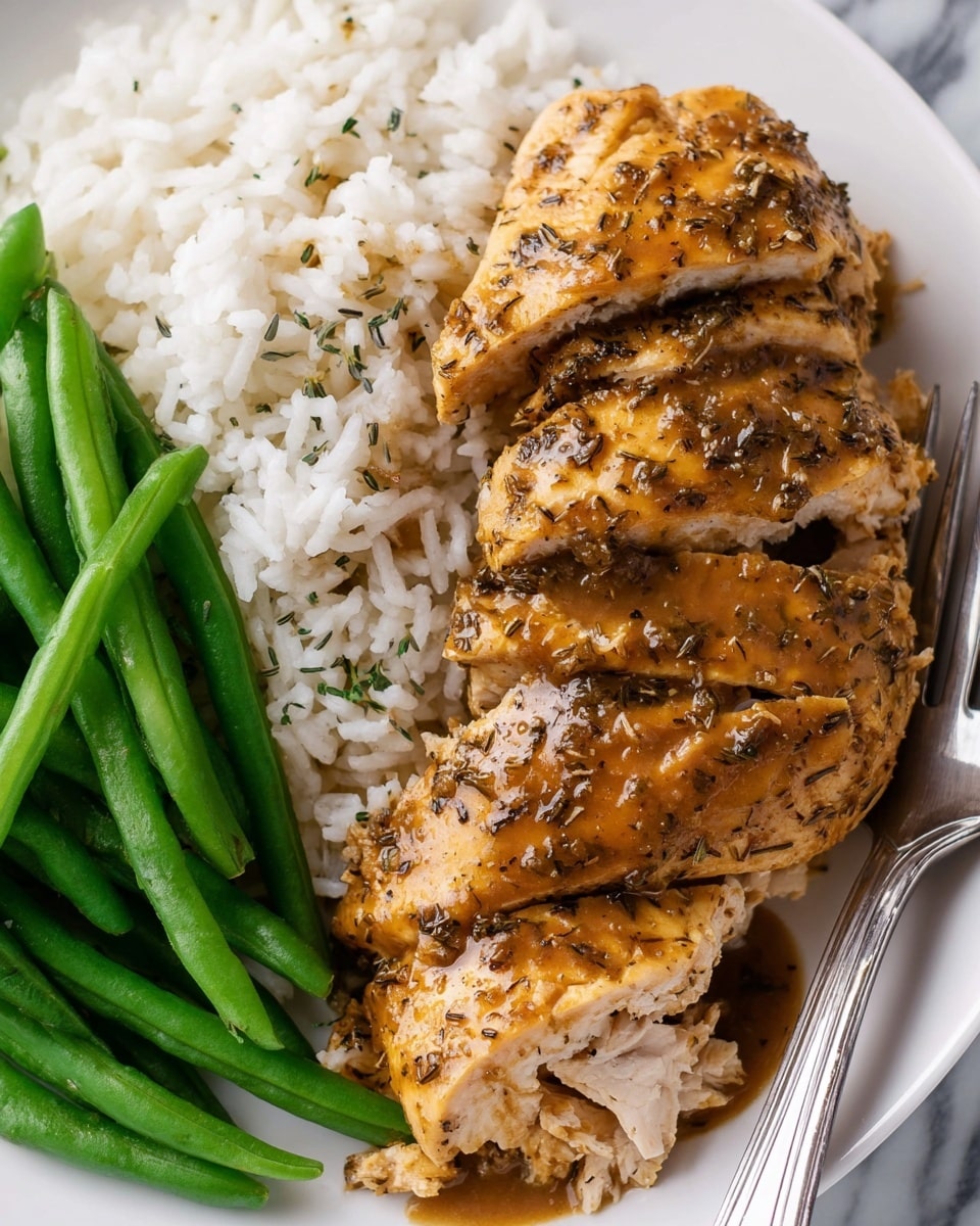 The image shows a white plate with three main layers of food: bright green, smooth textured green beans on the left; fluffy white rice with individual grains visible on the top; and several pieces of cooked chicken breast in the center and right, covered in a brown, glossy sauce with black pepper and herb specks, showing some fibrous texture inside. A silver fork rests on the right edge of the plate. The background has a white marbled texture. Photo taken with an iphone --ar 4:5 --v 7