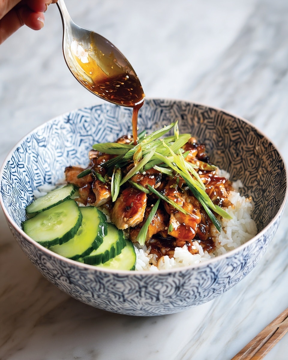 A white bowl with a blue geometric pattern holds a dish with three main layers: the bottom layer is fluffy white rice spreading across the bowl, the middle layer is grilled chicken pieces with a shiny brown sauce and green grilled scallions on top, and the top layer is thin slices of fresh green cucumber arranged neatly on one side. A spoon is pouring extra sauce over the chicken, held by a woman's hand, and a chopstick rests on the bowl's edge. The bowl sits on a white marbled surface. photo taken with an iphone --ar 4:5 --v 7