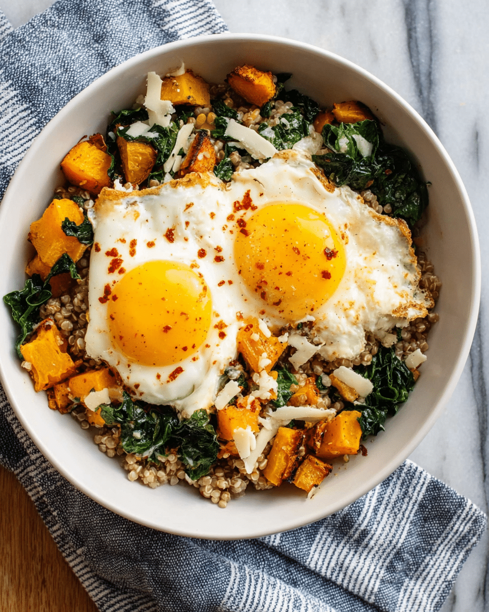 A white bowl holds a dish with three main layers. The bottom layer is a mix of cooked grains that are light brown and textured like farro or barley. On top of this there is a bright yellow and orange layer of cooked butternut squash pieces mixed with dark green leafy vegetables like kale, showing a soft and chunky texture. The top layer features two sunny-side-up eggs with bright yellow yolks and smooth white cooked whites, sprinkled lightly with red spice and black pepper. The bowl sits on a white marbled surface with a striped white and blue cloth beside it. photo taken with an iphone --ar 4:5 --v 7