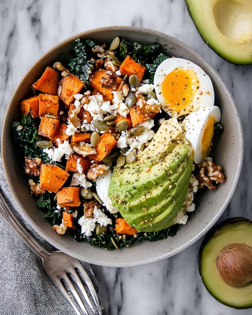 A white bowl filled with a colorful healthy salad sits on a white marbled surface. The base layer is dark green kale leaves, topped with bright orange roasted sweet potato cubes scattered all around. On one side, half a ripe avocado is sliced and sprinkled with black pepper and pumpkin seeds. Next to it, there are two halved soft-boiled eggs with bright yellow yolks and white edges, also dusted lightly with pepper. Crumbled white feta cheese is spread evenly over the salad, with a few walnut halves and pumpkin seeds adding texture. Photo taken with an iphone --ar 4:5 --v 7