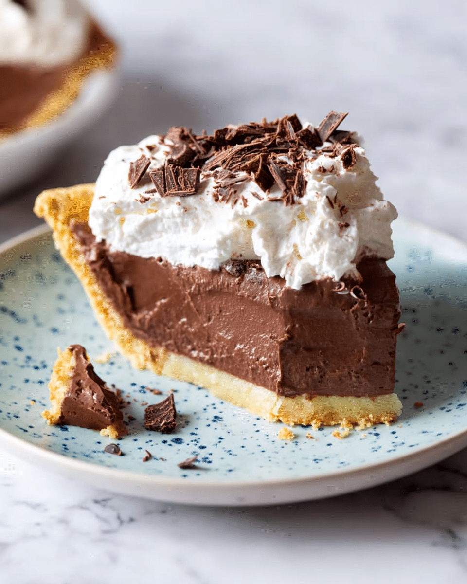 This image shows a chocolate pie with three slices visible on a white plate, sitting on a white marbled surface. The pie has a golden-brown, flaky crust that lines the edge, holding a smooth and shiny dark chocolate filling. The filling is thick and glossy with a slightly textured surface. One slice is topped with a dollop of white whipped cream and sprinkled with thin dark chocolate shavings, adding a contrast in color and texture. The whipped cream looks light and fluffy, sitting neatly on the pie. photo taken with an iphone --ar 4:5 --v 7