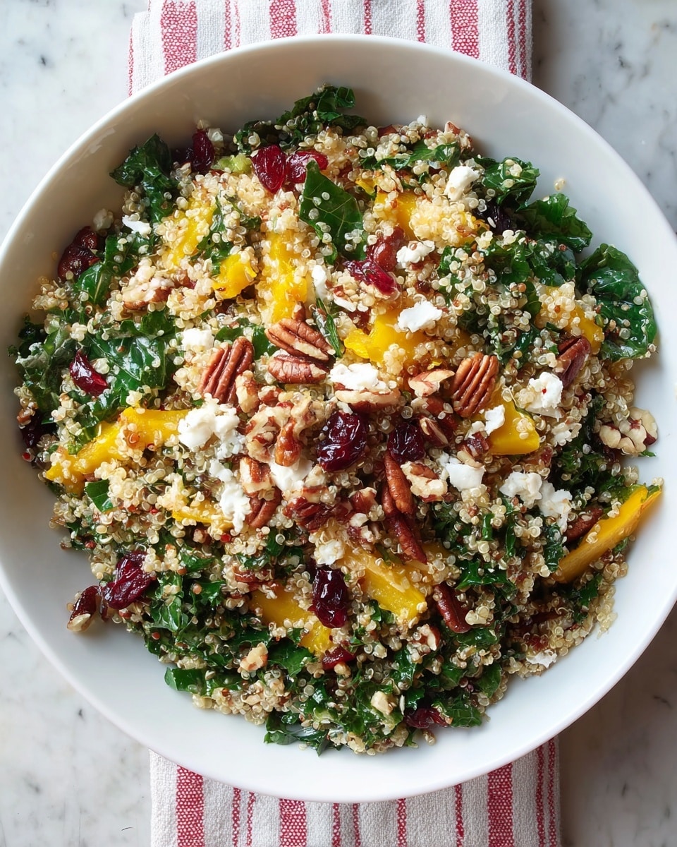 A bowl filled with a colorful quinoa salad showing about four layers: the bottom layer is light beige quinoa grains, mixed throughout with dark green leafy kale strips and bright yellow roasted squash pieces, scattered with deep red dried cranberries and small chunks of white crumbled cheese, topped with chopped brown pecans. The bowl is white and placed on a white marbled surface under soft natural light. photo taken with an iphone --ar 4:5 --v 7