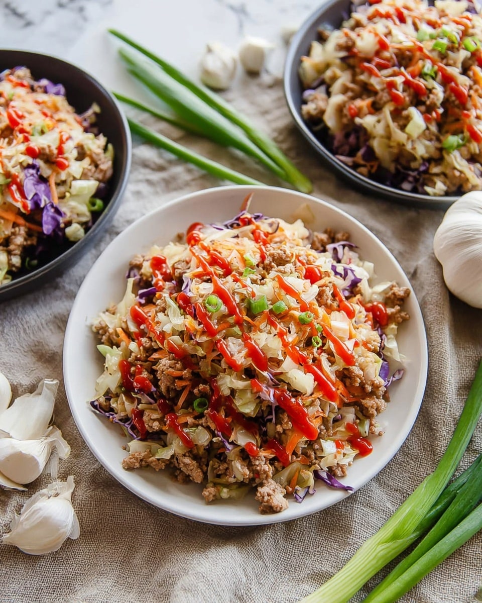 The image shows a dish served on a white plate filled with a mix of ground meat, finely chopped cabbage, and bits of purple cabbage, creating a mix of light beige, white, and purple colors. The top layer is decorated with bright red sauce drizzled in lines across the dish. The texture looks lightly chunky with small bits of meat and shredded cabbage mixed together. The plate sits on a beige cloth over a white marbled surface, surrounded by fresh green onions and garlic cloves for garnish. The dish is presented closely with two more similar plates blurred in the background. Photo taken with an iphone --ar 4:5 --v 7