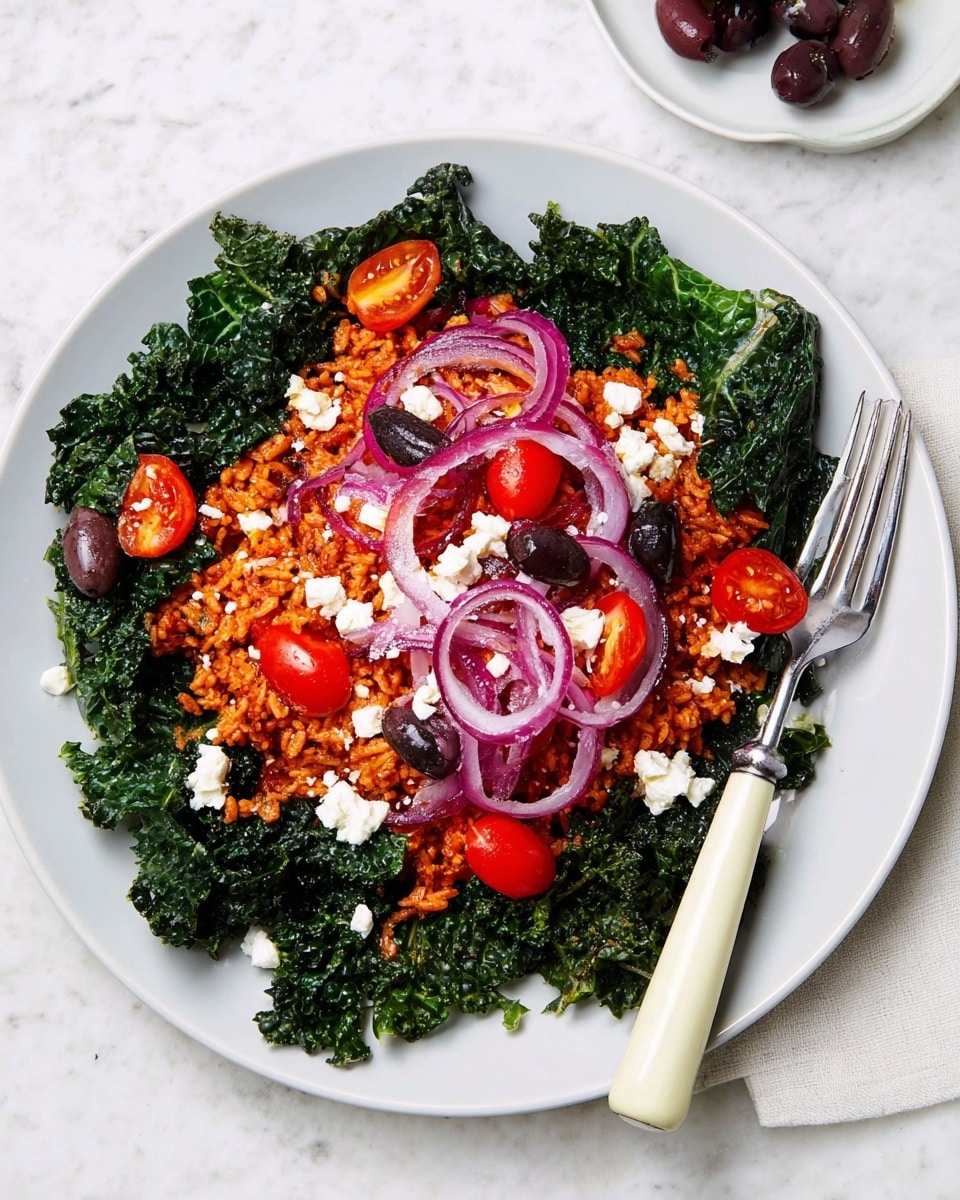 A white plate holds a layered Mediterranean-inspired dish arranged neatly. The bottom layer is dark green, wrinkled kale leaves forming a base that rings the plate’s edge. On top of the kale is a mound of reddish-orange rice, textured and slightly glossy. Scattered over the rice and kale are small white crumbles of cheese. Halved dark purple olives and thin, curved slices of light purple-red onion are placed across the dish, along with bright red cherry tomato halves. A silver fork with a white handle rests at the bottom edge of the plate, holding one olive. The plate sits on a white marbled surface with a beige napkin partially visible. photo taken with an iphone --ar 4:5 --v 7