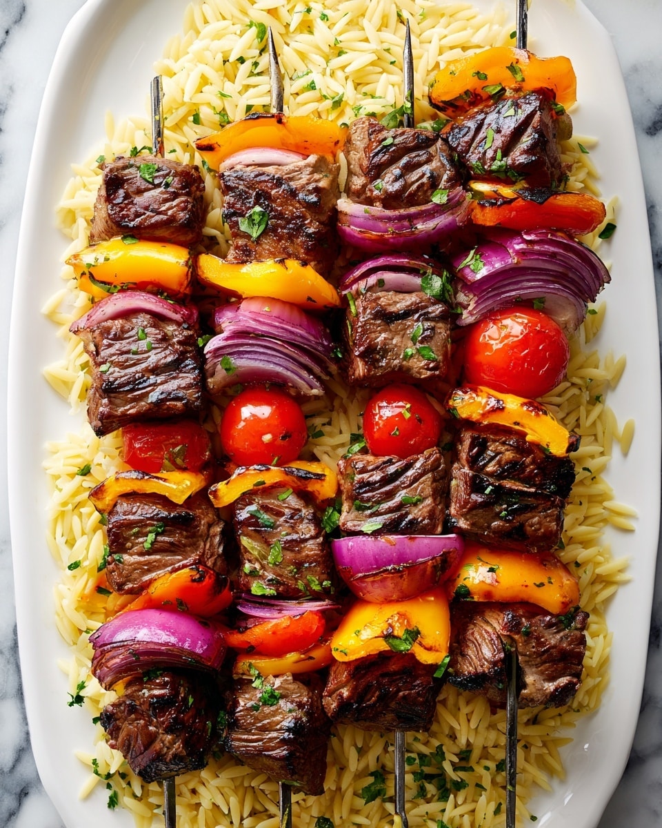 The image shows a white rectangular plate filled with four skewers of grilled beef kebabs on a bed of yellowish orzo rice garnished with chopped green herbs. Each skewer has layers starting from the bottom with a chunk of grilled beef, followed by slices of purple-red onion, bright orange and yellow bell peppers, and a bright red cherry tomato. The beef pieces are dark brown with charred grill marks, while the vegetables show slight charring and vibrant colors. The orzo rice underneath is light yellow with some green herbs sprinkled across it, all set against a white marbled surface. Photo taken with an iphone --ar 4:5 --v 7