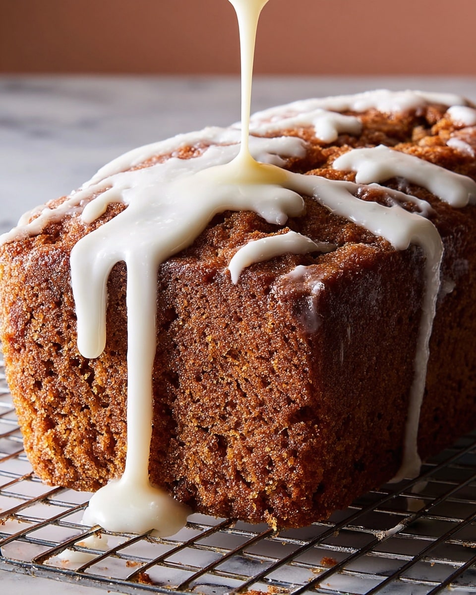 A close-up view of a brown loaf cake with a rough, cracked top texture sitting on a metal cooling rack over a white marbled surface. The top of the cake is being drizzled with thick white icing that spreads unevenly, running down the sides in long drips. The loaf has a dense and moist crumb with a slightly moist crust, and the icing adds a smooth, shiny contrast to the rough cake surface. Photo taken with an iphone --ar 4:5 --v 7