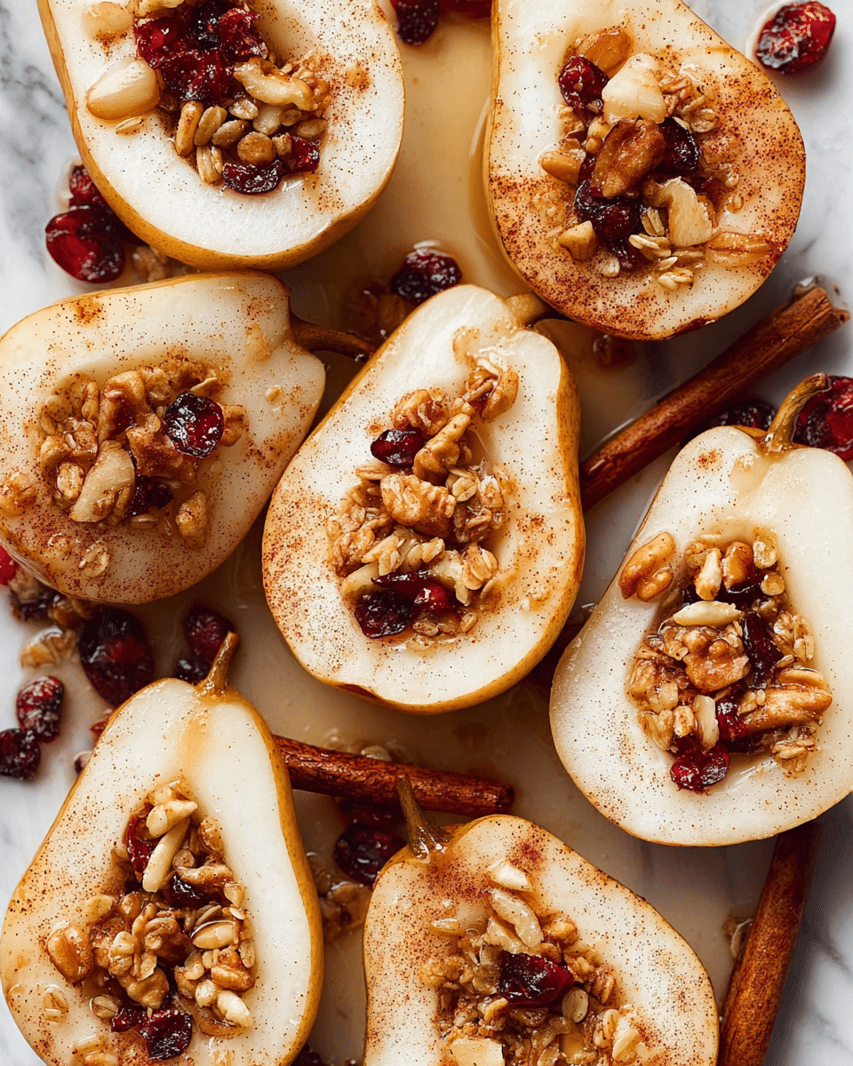 Several pear halves are arranged closely together on a white marbled surface, each cut side up showing the pale cream flesh with a round hollow in the center filled with a mix of granola pieces, walnuts, and dried cranberries. The skin of the pears is light brown with a smooth texture, while the granola filling adds a rough, crumbly contrast. A light dusting of cinnamon powder is scattered over the pears, some pieces slightly soaked in a glossy syrup that shines softly in the light. Sticks of cinnamon are also visible among the pears, adding a rich brown tone to the composition. photo taken with an iphone --ar 4:5 --v 7