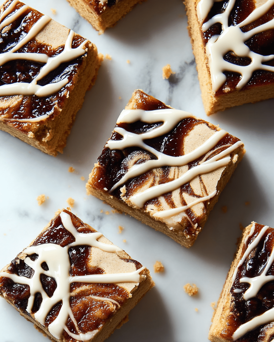 The image shows several square pieces of a two-layer dessert on a white marbled surface. The bottom layer is thick, dense, and light brown with a soft crumbly texture. The top layer has a dark brown swirl that looks sticky and glossy, mixed into the light brown base. Over this, there is a drizzle of smooth, off-white icing spread unevenly in wavy lines across each square piece. The pieces are closely placed but not touching each other, showing clear edges and crumbs around them. photo taken with an iphone --ar 4:5 --v 7