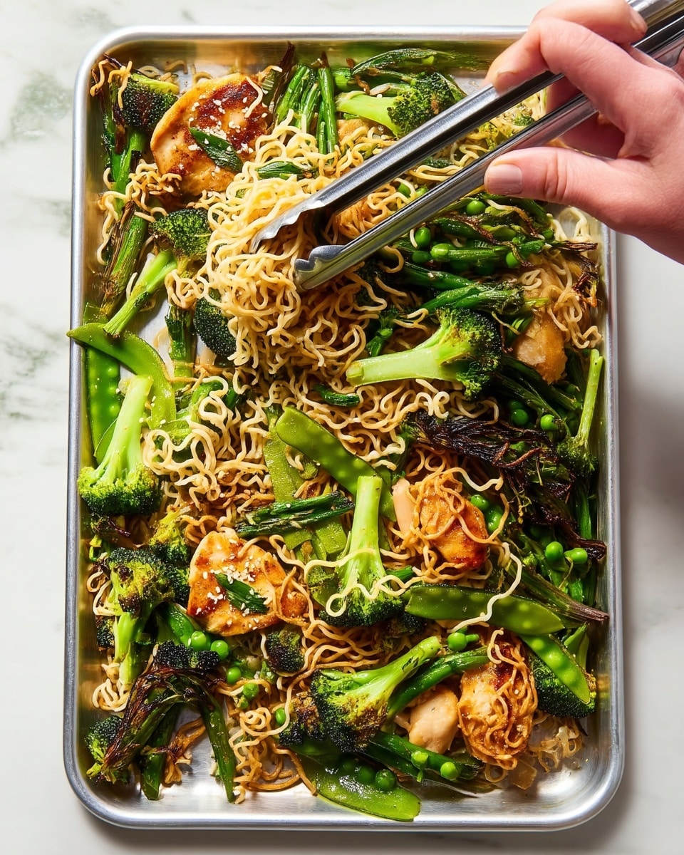 A tray filled with a mix of light brown cooked noodles, bright green broccoli florets with some charred edges, and snap peas scattered throughout sits on a white marbled surface. There are pieces of golden brown chicken with slight grill marks, along with small pieces of dark green scallions mixed in. A white bowl with a thin dark rim holds a serving of the same noodle and vegetable mix, with silver metal tongs picking up some noodles. A woman's hand is seen holding the tongs from above. The textures range from soft noodles to crispy vegetables, creating a fresh and colorful meal. Photo taken with an iphone --ar 4:5 --v 7