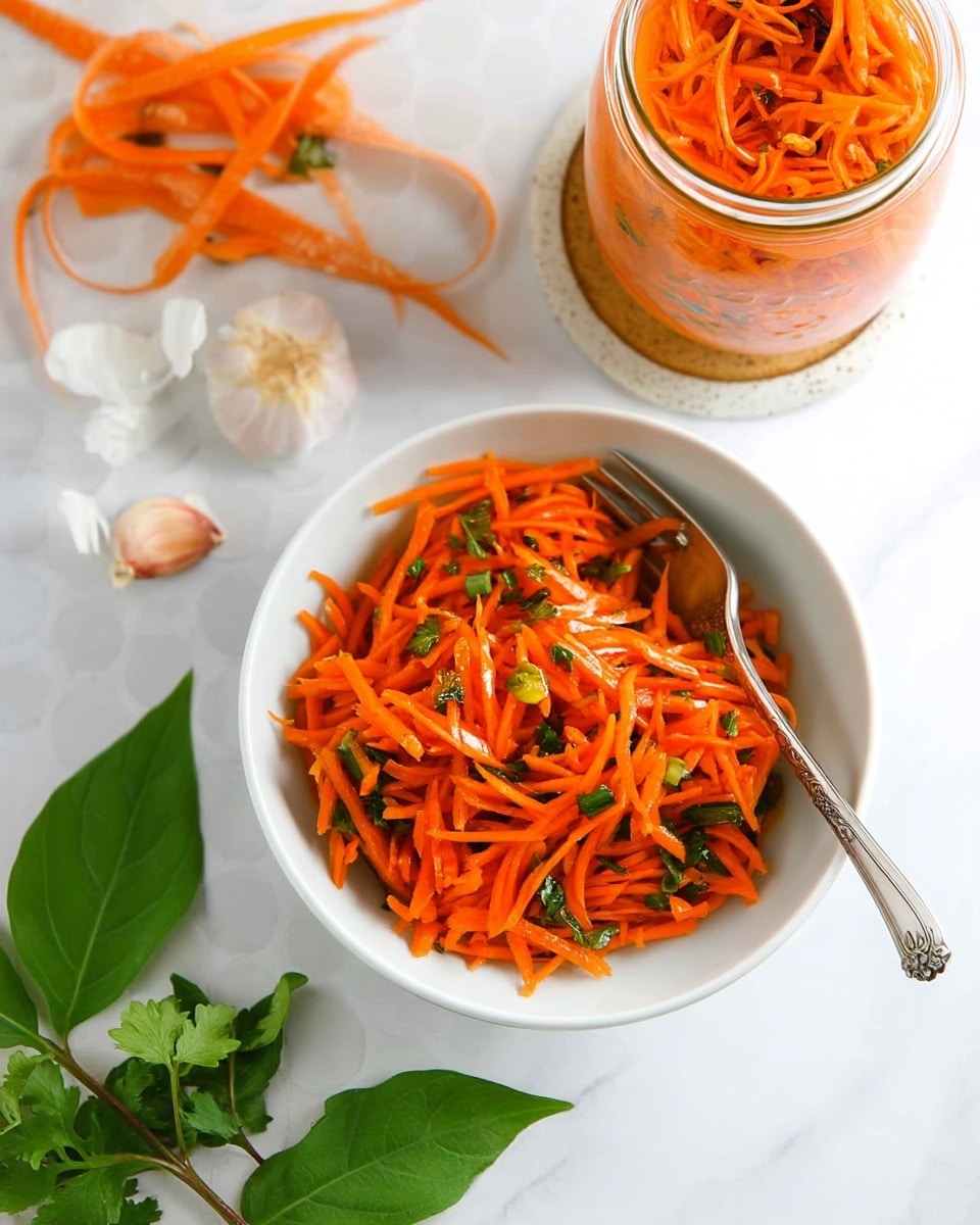 The image shows a dish of shredded orange carrots mixed with small green herb pieces. The carrot mix is placed mainly in a white speckled bowl near the bottom center, with a silver spoon inside. Above it, there is a large glass jar and a smaller glass jar, both filled to the top with the same shredded carrot mixture. To the left, there are some carrot peelings and green cilantro leaves on a white marbled surface. Near the bottom left, there is garlic with partially peeled white skin and more cilantro. The overall colors are bright orange, green, white, and silver, set against a white marbled background. photo taken with an iphone --ar 4:5 --v 7